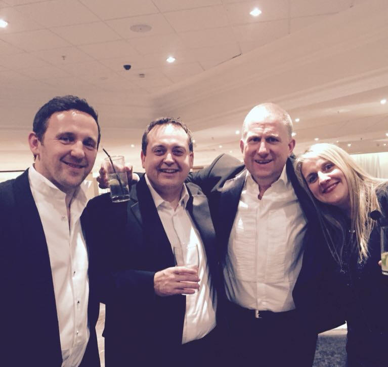 Roger Percy with friends at an evening event